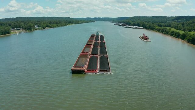 Drone flying over large coal barge on the Ohio river