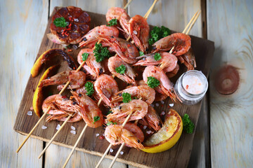 Shrimp kebabs. Grilled shrimp on sticks. Delicious shrimp with spices and lemon.