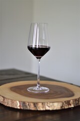 glass of red wine on wooden table