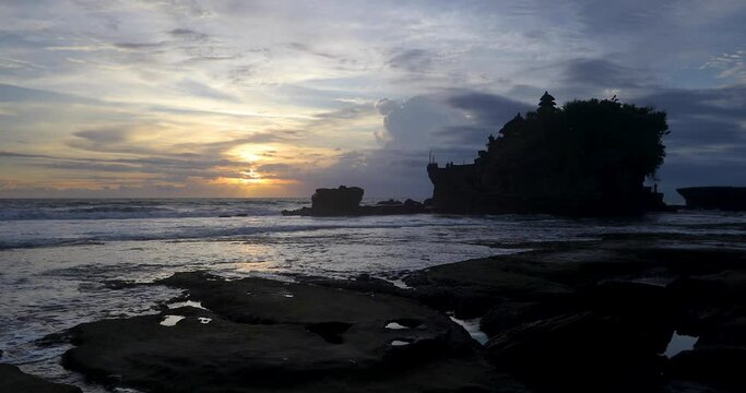 4k resolution video of the famous Hindu temple of Tanah Lot located along the western coastline of Bali in Indonesia.