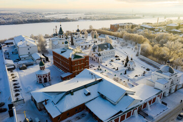 Fototapeta premium View from drone of Murom Transfiguration Monastery on background with cityscape on sunny winter day, Russia.