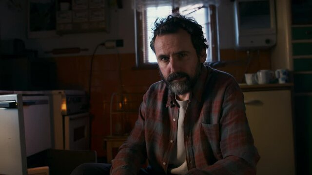 Portrait of poor mature man with empty wallet indoors at home, poverty concept.
