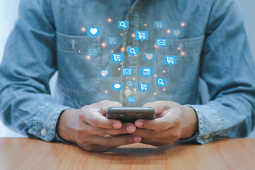 Social media interactions on smart mobile phone. Concept of notification icons of like, message, email and comment. Hands holding the device.