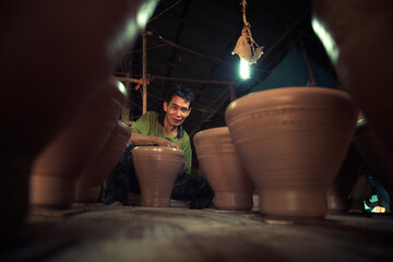 A professional Thai old man uses artisanal pottery from Thailand, Asia.