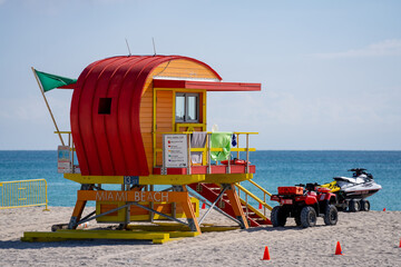 Fototapeta na wymiar Orange lifeguard toewr Miami Beach FL with green flag safe swimming conditions