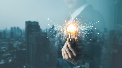 Innovation through ideas and inspiration ideas. Human hand holding  light bulb to illuminate, idea...