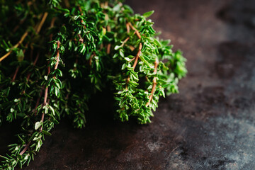 Freshly harvested bunch of thyme on the rustic background. Selective focus. Shallow depth of field.