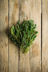Freshly harvested bunch of thyme on the rustic background. Selective focus. Shallow depth of field.