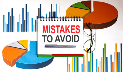 Mistakes To Avoid text on notepad on the chart background with pen and glasses