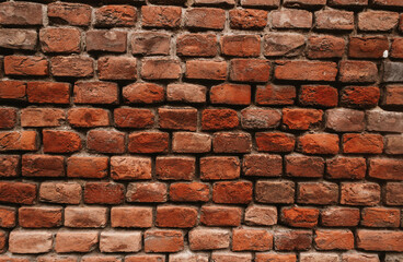 The texture of an old brick wall with natural defects. Scratches, cracks, crevices, chips, dust, roughness, abrasion. Template for design and background.Copy space