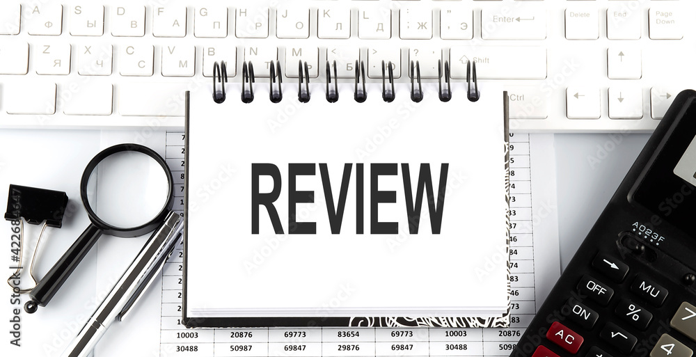 Aufkleber white notebook with text review on the white keyboard with calculator,magnifier and pen