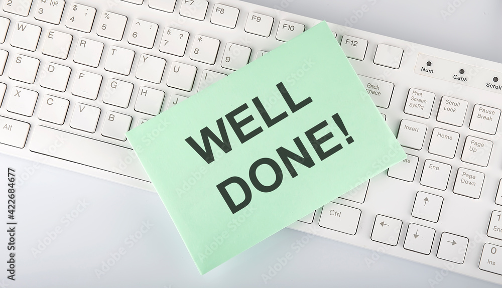 Aufkleber text well done on envelope on keyboard on the white background