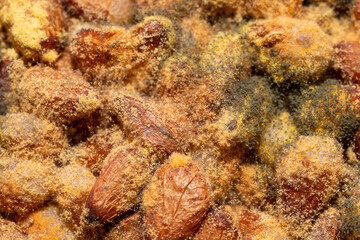 Obraz na płótnie Canvas Mold on pine nuts. Macro of yellow and green spores and fungi growing on nuts.