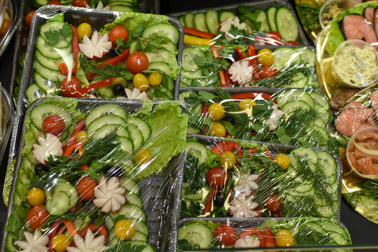 ready-made salads in plastic packaging. Fast healthy food. Vegetable salad on counter of the store. Vegetarian food, diet. Food delivery