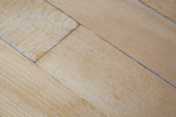 old parquet or laminate flooring deformed by water exposure. water exposure, wet coating close-up