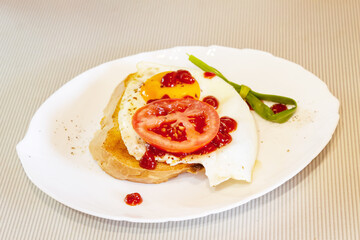 Fried egg with tomato, onion and tomato paste on toast