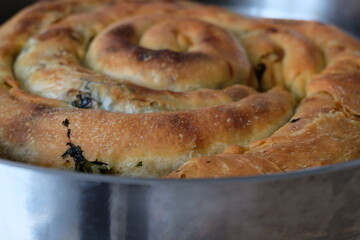 Traditional Turkish pastry with spinach, selective focus, close up. It is called 