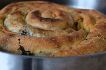 Traditional Turkish pastry with spinach, selective focus, close up. It is called 