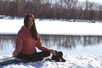 girl meditates in nature in winter. lotus position