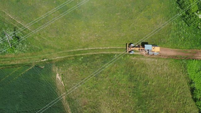 Road leveling tractor grader on  rural road at work, aerial view

