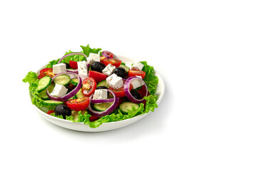 Vegetable salad with olives and feta cheese on a white background. Greek salad.