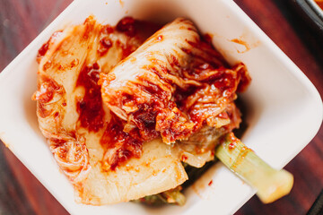 Homemade Cabbage Kimchi served in a little white cup.