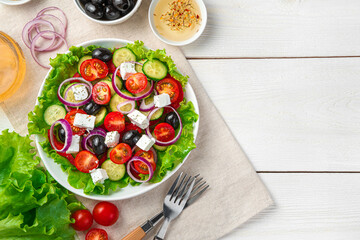 Culinary background with Greek salad and copy space. Top view, horizontal.