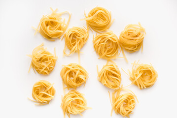 pasta on a white plate, not cooked pasta on a white plate, pasta nest on a white plate 