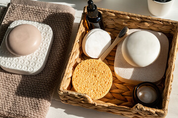 Bamboo acessories for bath - basket, soap bars, brushes, tooth brush, towel and organic face oil for personal hygiene. Zero waste, plastic free, sustainable decor for bathroom interior