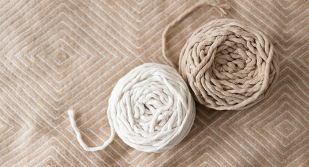 Roll of macrame rope. White and gray thread on a beautiful pastel background, flat image.