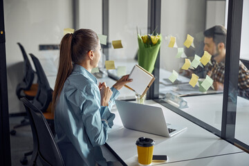 Female employee with a ponytail sitting at the desk