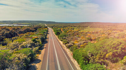 Obraz premium Road across the island, aerial view from drone on a beautiful sunny day. Holiday and vacation concept