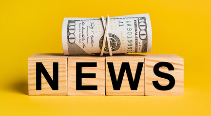 NEWS with money on a yellow background. The concept of business, finance, credit, income, savings, investments, exchange, tax