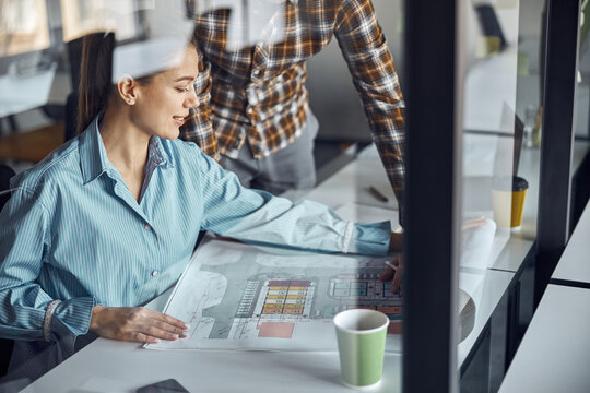 Two designers working at a new building plan