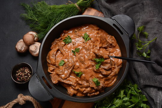 Beef Stroganoff with cremini and champignons on a frying pan.