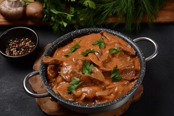 Traditional beef stroganoff with cremini and champignons in casserole