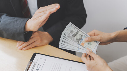 Business people giving a bribe of money at contract, Corruption concept..