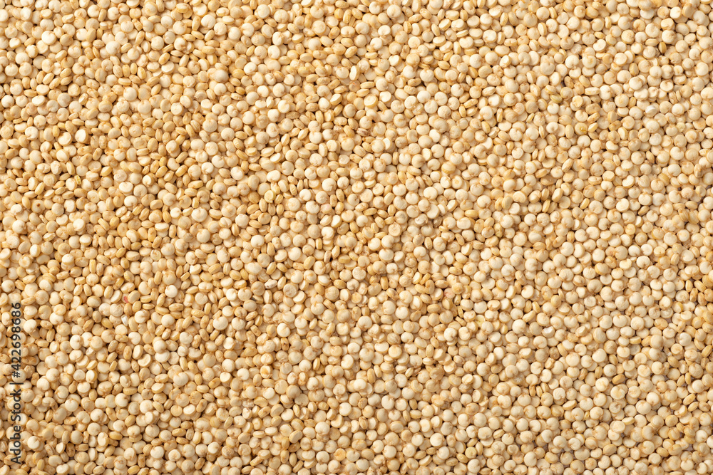 Wall mural food background of raw quinoa, top view