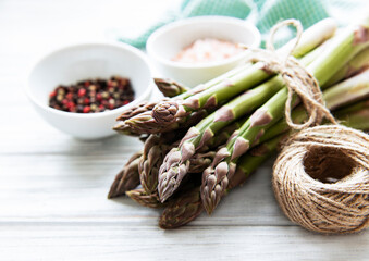 Bunch of raw asparagus stems with different spices