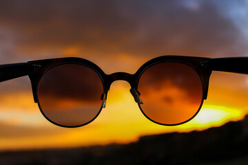 Sunglasses with a sunset in the background