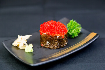 Salmon roe rolls served with pickled ginger and wasabi