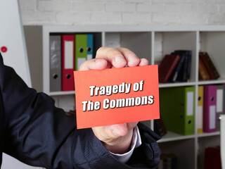  Financial concept about Tragedy of The Commons with inscription on the piece of paper.