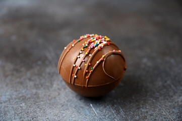Cocoa bomb with marshmallows, chocolate that melts when hot milk is added for creating a trendy...