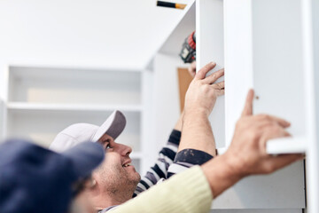 Handyman worker fixing and assembling household furniture.