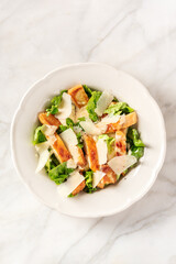 Caesar salad with grilled chicken, romaine and Parmesan cheese
