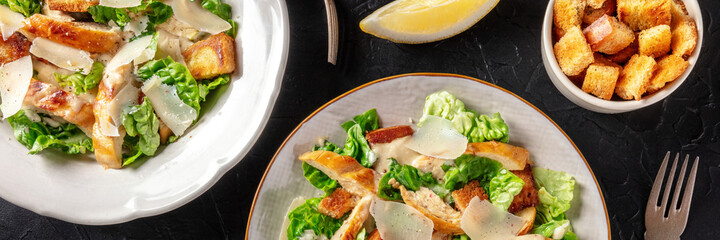 Caesar salad panorama on a dark background