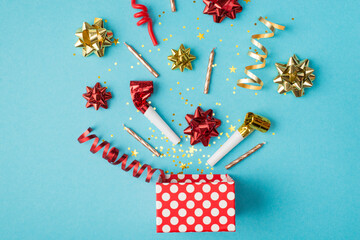 Top view photo of birthday composition blast of tinsel sparkles serpentine red yellow golden ribbon...