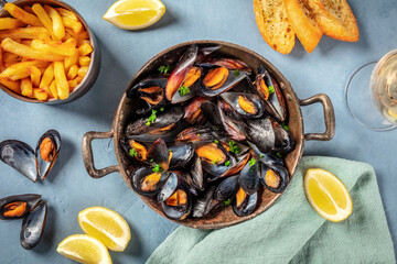 Mussels, overhead flat lay shot on a blue background