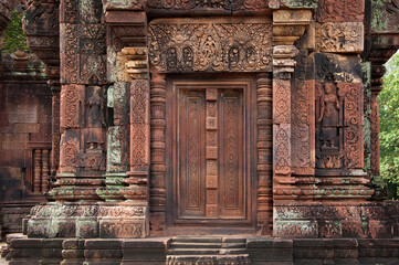 Fototapeta na wymiar Decorative door stone carving at Banteay Srei (Banteay Srey) ancient temple made of pink sandstone dedicated to the Hindu god Shiva, Angkor Wat, Khmer culture, Siem Reap, Cambodia