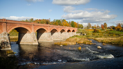 Fototapeta na wymiar Long brick bridge in autumn, Kuldiga, Latvia.